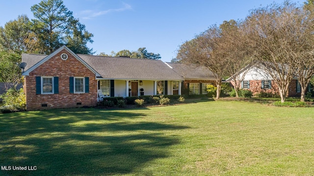 ranch-style house featuring covered porch and a front lawn