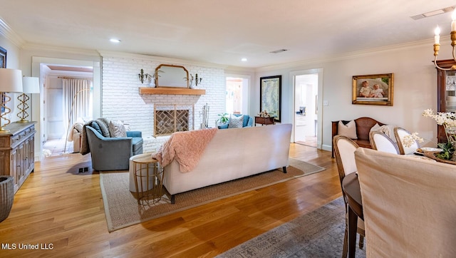 102 Melrose Montebello Pkwy, Natchez, MS 39120 - living area featuring ornamental molding, light wood finished floors, a brick fireplace, and recessed lighting