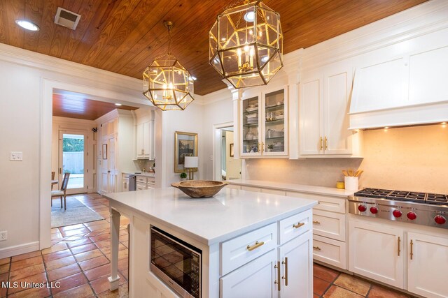 102 Melrose Montebello Pkwy, Natchez, MS 39120 - kitchen featuring built in microwave, stainless steel gas cooktop, a chandelier, wood ceiling, and light countertops