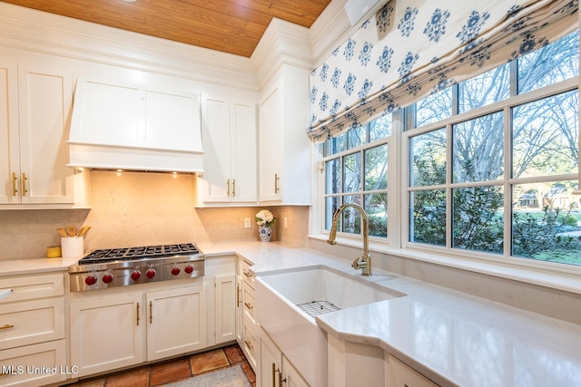 102 Melrose Montebello Pkwy, Natchez, MS 39120 - kitchen with custom exhaust hood, stainless steel gas cooktop, light countertops, tasteful backsplash, and wooden ceiling