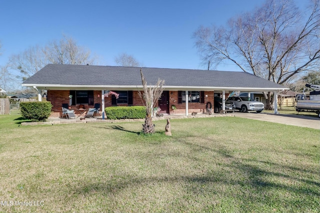 ranch-style home featuring a shingled roof, an attached carport, fence, a front lawn, and brick siding