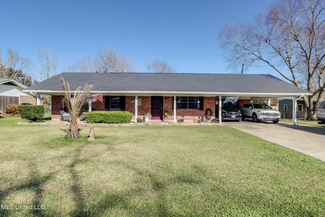 ranch-style home featuring a shingled roof, concrete driveway, an attached carport, a front lawn, and brick siding