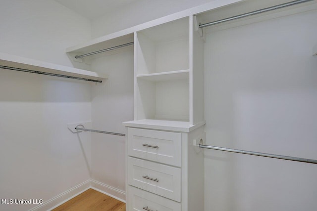 walk in closet featuring light hardwood / wood-style flooring