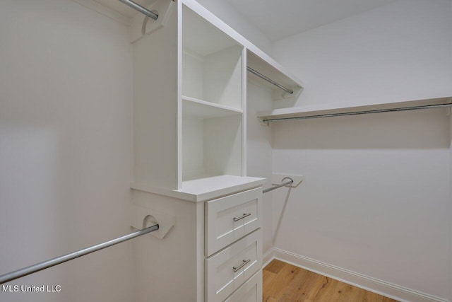 spacious closet with light hardwood / wood-style floors