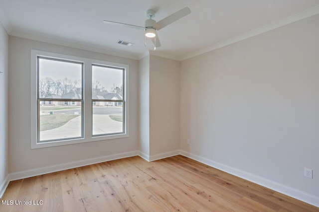 empty room with ceiling fan, ornamental molding, and light hardwood / wood-style floors