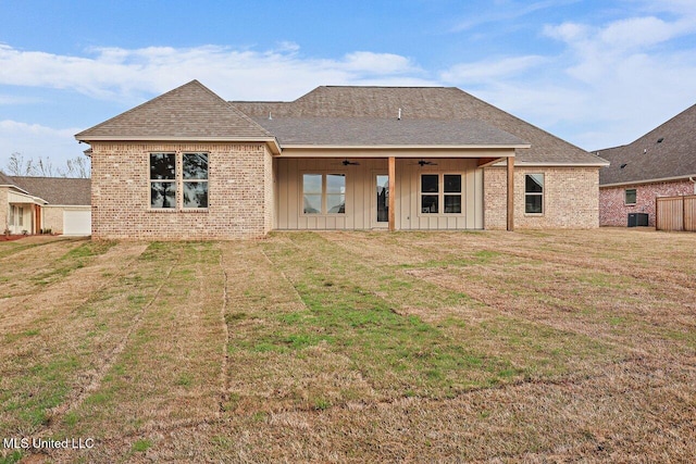 back of house featuring ceiling fan, central AC unit, and a lawn