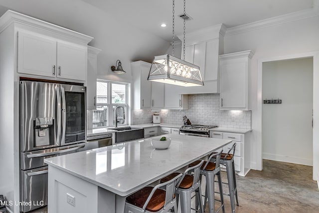 625 Wild Horse Ln, Brandon, MS 39042 - kitchen with stainless steel appliances, decorative backsplash, a kitchen island, light stone countertops, and a kitchen breakfast bar