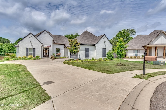 625 Wild Horse Ln, Brandon, MS 39042 - french country home with concrete driveway, a front lawn, and an attached garage