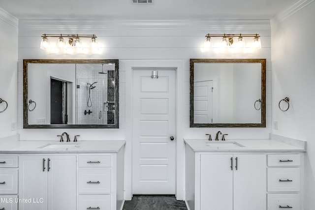 625 Wild Horse Ln, Brandon, MS 39042 - bathroom with a shower stall, two vanities, and crown molding