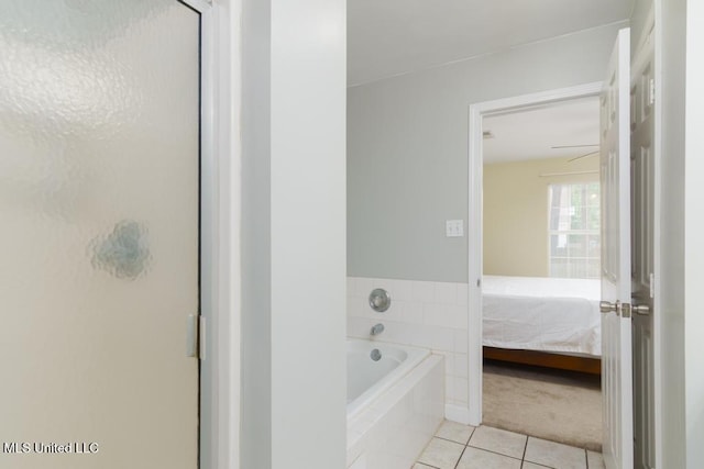 ensuite bathroom with tile patterned floors, a garden tub, and a stall shower