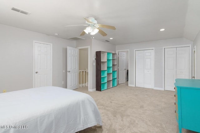 bedroom featuring light carpet, multiple closets, recessed lighting, ceiling fan, and baseboards