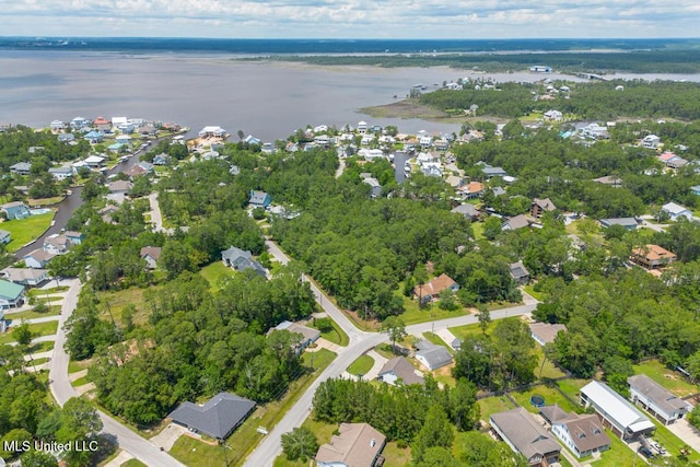 aerial view of property and surrounding area featuring a large body of water and nearby suburban area