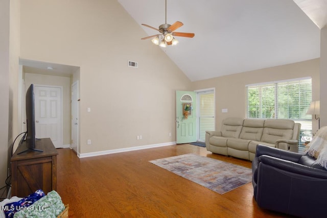 living area featuring high vaulted ceiling, a ceiling fan, wood finished floors, and baseboards