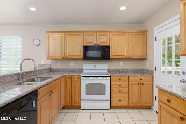 kitchen with black appliances, a sink, light tile patterned floors, light brown cabinets, and recessed lighting