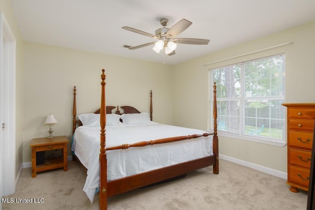 bedroom featuring light carpet, baseboards, and a ceiling fan