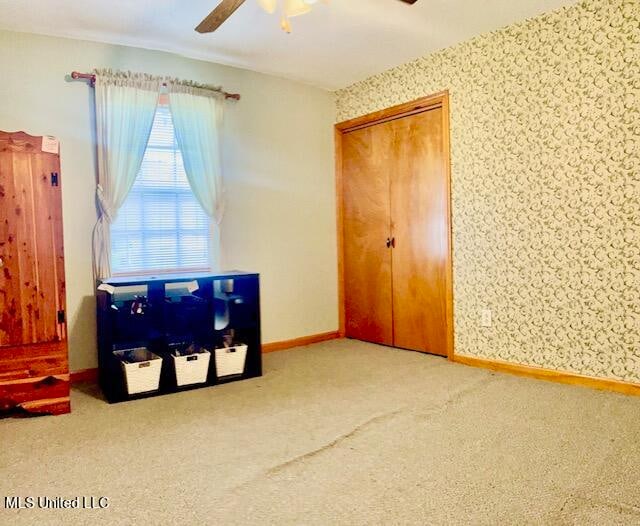 bedroom featuring carpet flooring, a closet, and ceiling fan