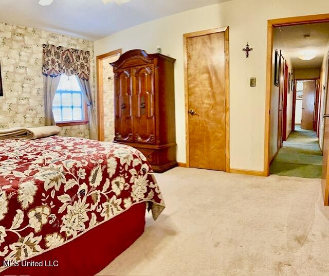 bedroom with ceiling fan and light colored carpet