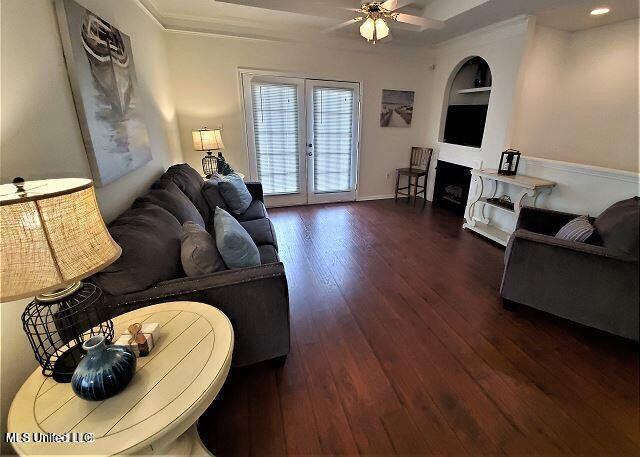 2252 Beach Dr Unit 1704, Gulfport, MS 39501 - living area featuring ceiling fan, wood finished floors, built in features, french doors, and crown molding