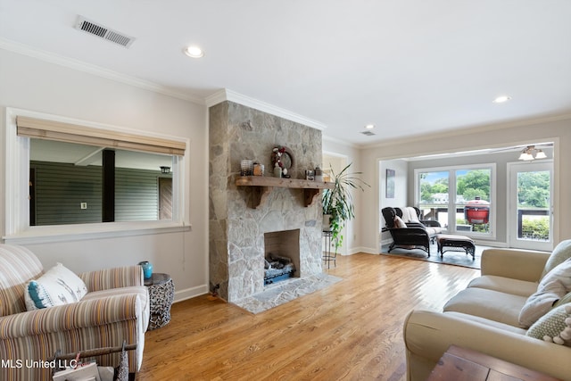 7300 W Shahkoka Dr, Olive Branch, MS 38654 - living room with baseboards, light wood-type flooring, ornamental molding, a fireplace, and recessed lighting