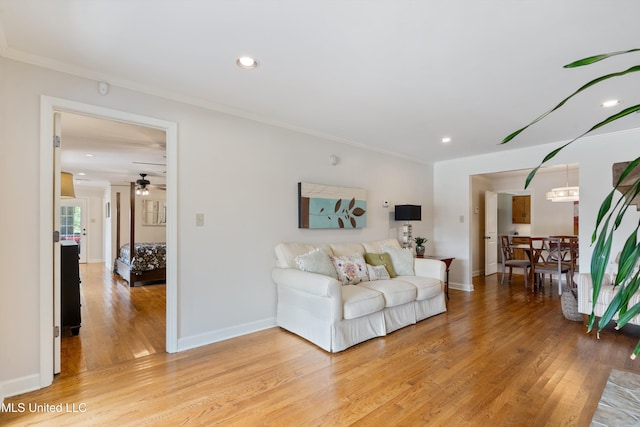 7300 W Shahkoka Dr, Olive Branch, MS 38654 - living area featuring crown molding, light wood finished floors, a ceiling fan, recessed lighting, and baseboards