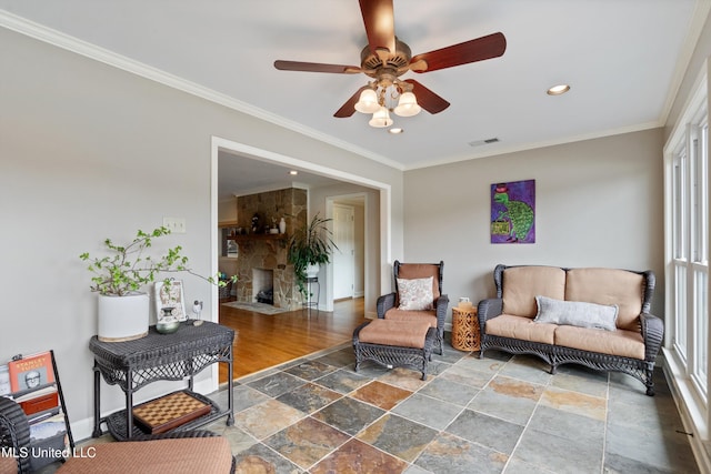 7300 W Shahkoka Dr, Olive Branch, MS 38654 - living area with stone tile floors, a ceiling fan, recessed lighting, crown molding, and baseboards