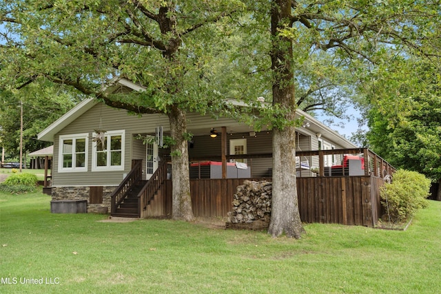 7300 W Shahkoka Dr, Olive Branch, MS 38654 - back of property with a lawn, a deck, and stairway