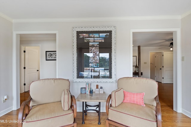 7300 W Shahkoka Dr, Olive Branch, MS 38654 - living area with crown molding, wood finished floors, baseboards, and ceiling fan