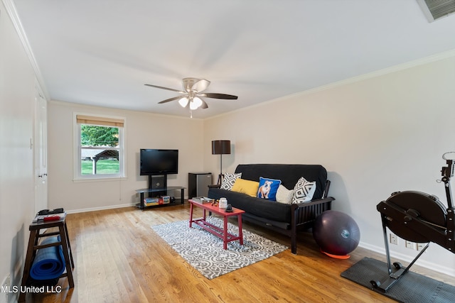 7300 W Shahkoka Dr, Olive Branch, MS 38654 - living room with wood finished floors, baseboards, crown molding, and ceiling fan