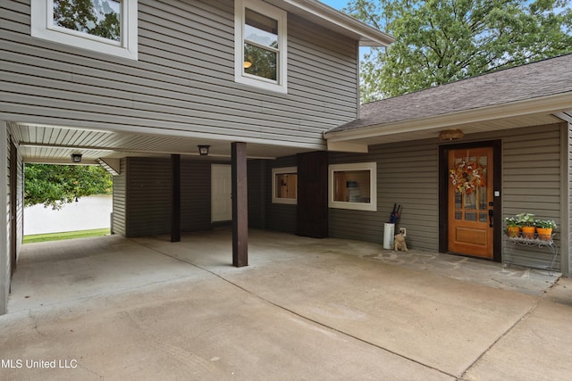 7300 W Shahkoka Dr, Olive Branch, MS 38654 - entrance to property with concrete driveway, roof with shingles, and a carport