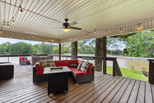 7300 W Shahkoka Dr, Olive Branch, MS 38654 - wooden deck with an outdoor living space with a fire pit, a ceiling fan, and a water view