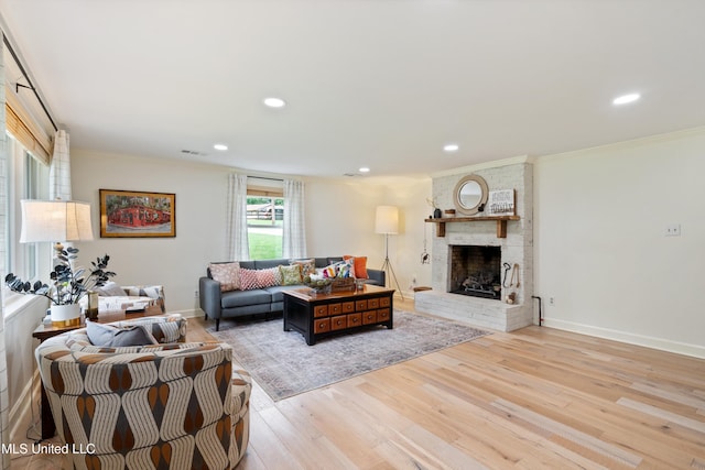 7300 W Shahkoka Dr, Olive Branch, MS 38654 - living room featuring a brick fireplace, wood finished floors, ornamental molding, recessed lighting, and baseboards