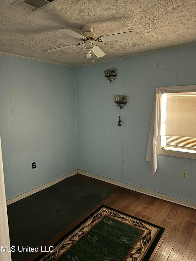 unfurnished room with hardwood / wood-style floors, a textured ceiling, and ceiling fan