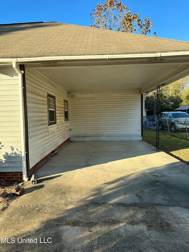 view of vehicle parking with a carport