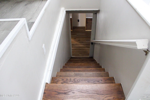 stairway with wood finished floors