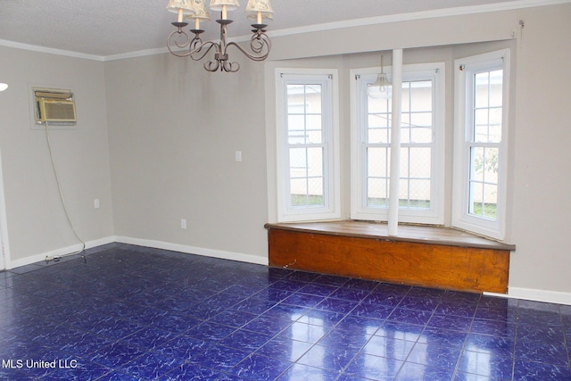 empty room featuring ornamental molding, an AC wall unit, a chandelier, and baseboards