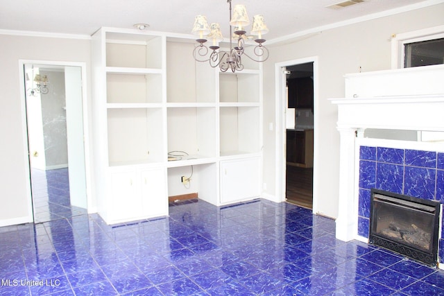 unfurnished dining area featuring ornamental molding, a tile fireplace, baseboards, and an inviting chandelier