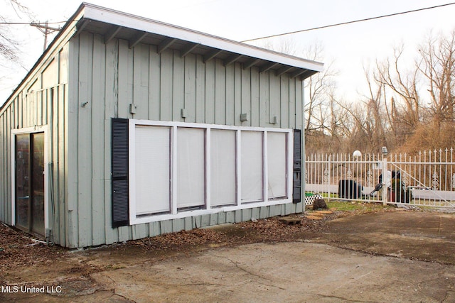 view of outbuilding featuring fence