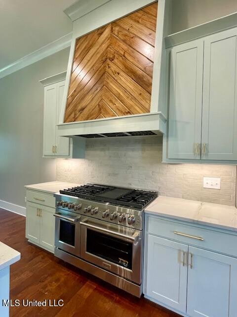 kitchen with dark hardwood / wood-style flooring, range with two ovens, ornamental molding, and tasteful backsplash