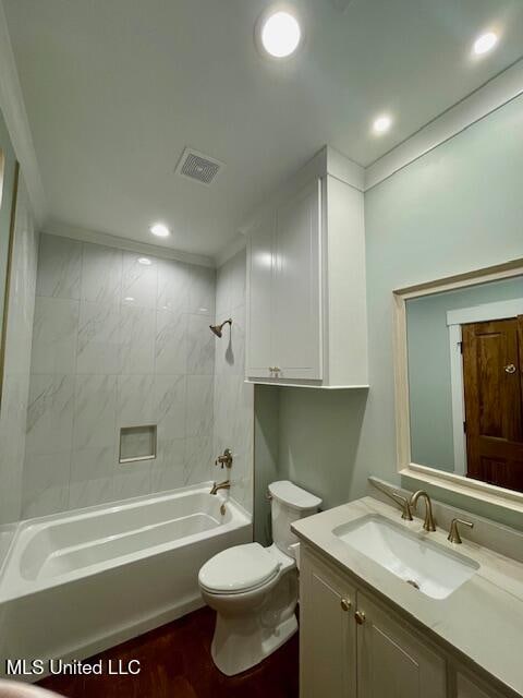 full bathroom with vanity, toilet, and tiled shower / bath