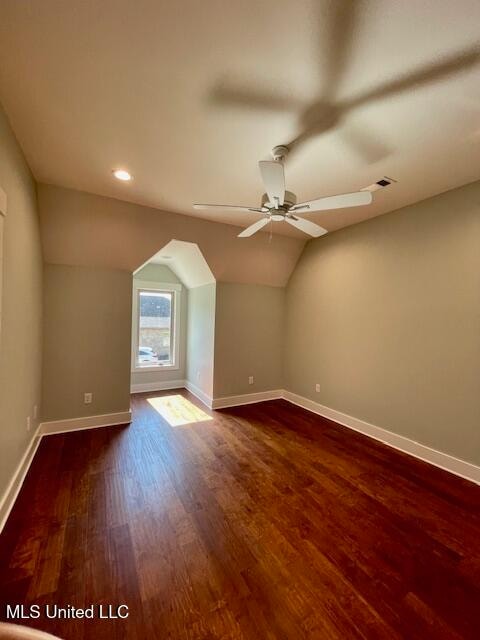 bonus room with ceiling fan, dark hardwood / wood-style flooring, and vaulted ceiling