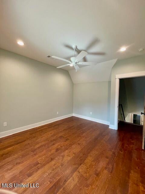 empty room featuring ceiling fan, dark hardwood / wood-style flooring, and lofted ceiling