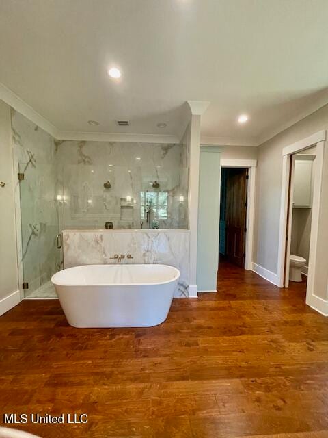 bathroom with hardwood / wood-style floors, ornamental molding, and plus walk in shower