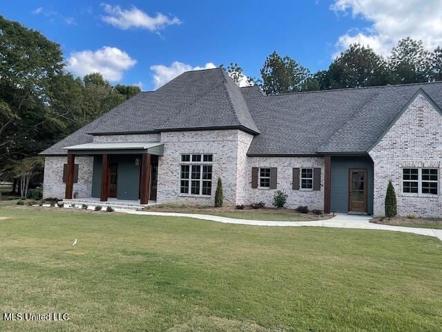 french country home featuring a front yard