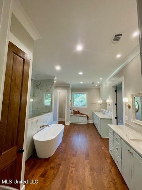 bathroom with vanity, shower with separate bathtub, wood-type flooring, and crown molding