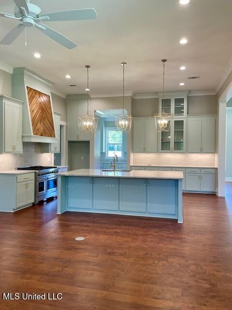 kitchen featuring dark hardwood / wood-style floors, range with two ovens, and a spacious island