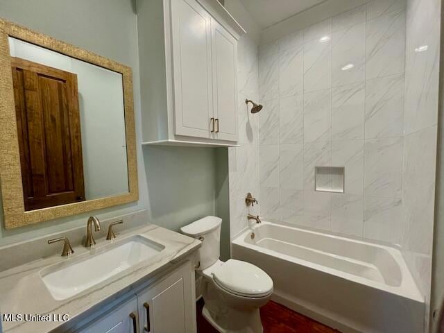 full bathroom with vanity, toilet, and tiled shower / bath