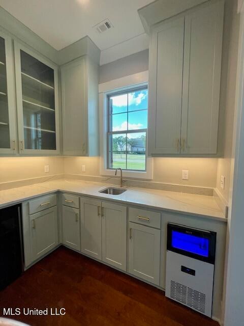 kitchen featuring sink, white cabinets, and dark hardwood / wood-style floors