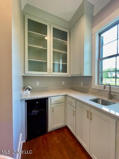 kitchen with white cabinets, dishwasher, dark hardwood / wood-style flooring, and sink