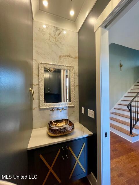 bathroom featuring vanity and tile walls