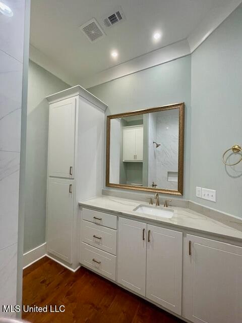 bathroom with hardwood / wood-style flooring and vanity